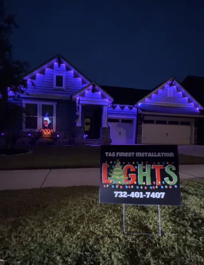 Home with purple permanent lighting and a T&S Finest Installation yard sign